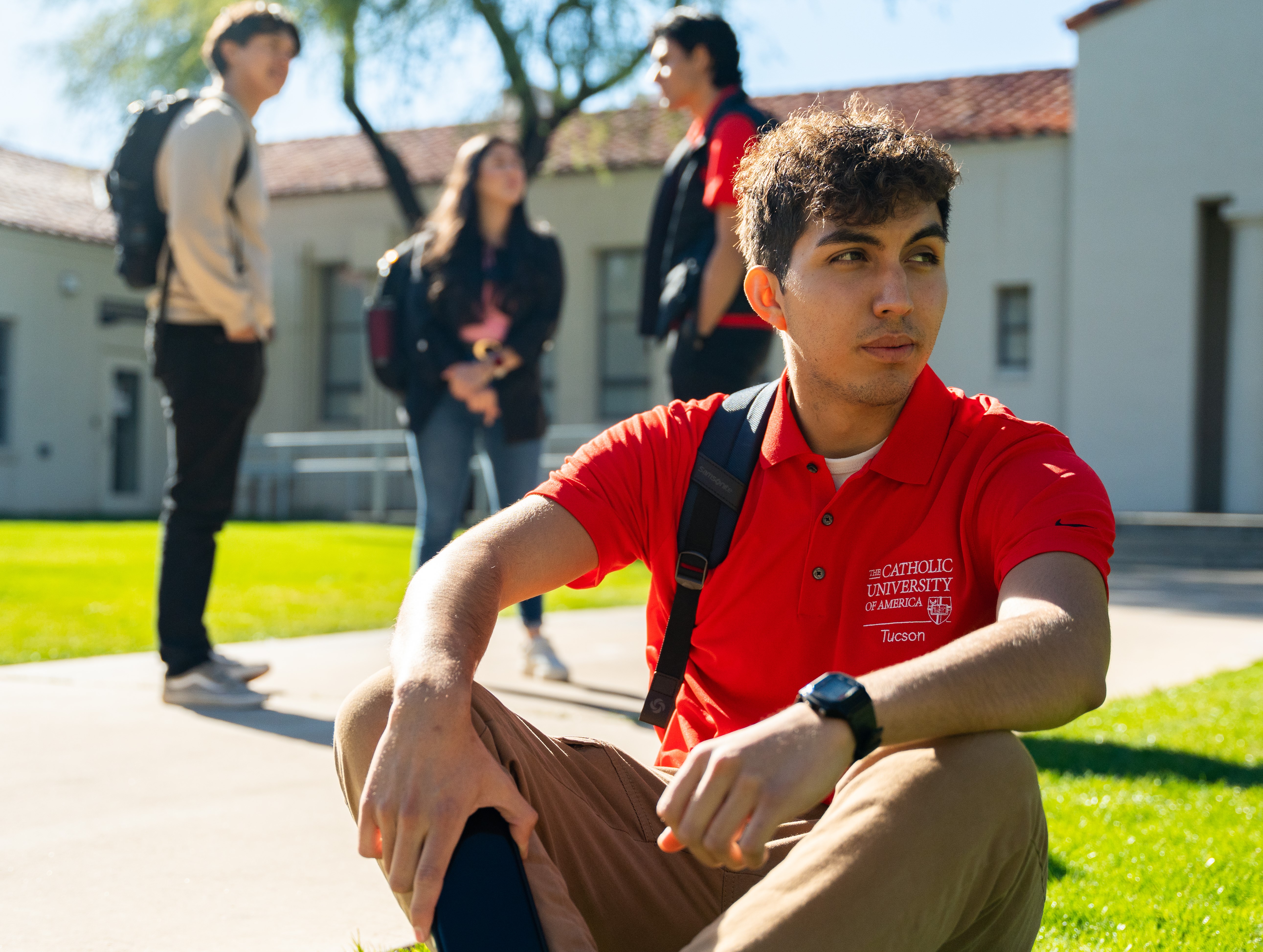 student on lawn looking into distance